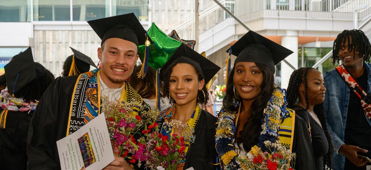 Three students celebrate Black Graduation.