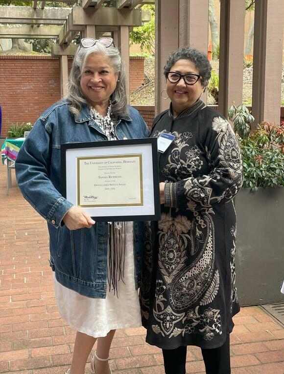 Sandy receiving the Social Sciences Distinguished Service Award for 2025 with Dean Raka Ray.